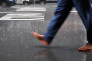 man wearing blue pants walking on street