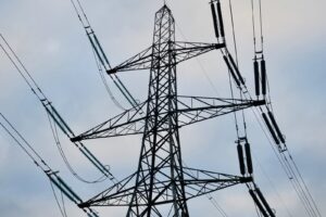 a high voltage power line against a cloudy sky