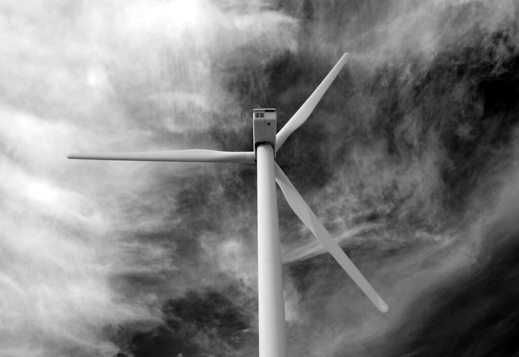 grayscale photo of wind turbine