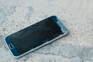 blue samsung android smartphone on gray marble table