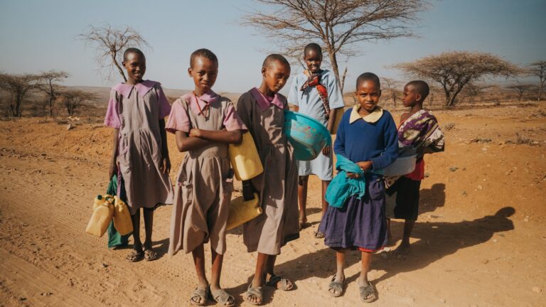 six children standing on desert