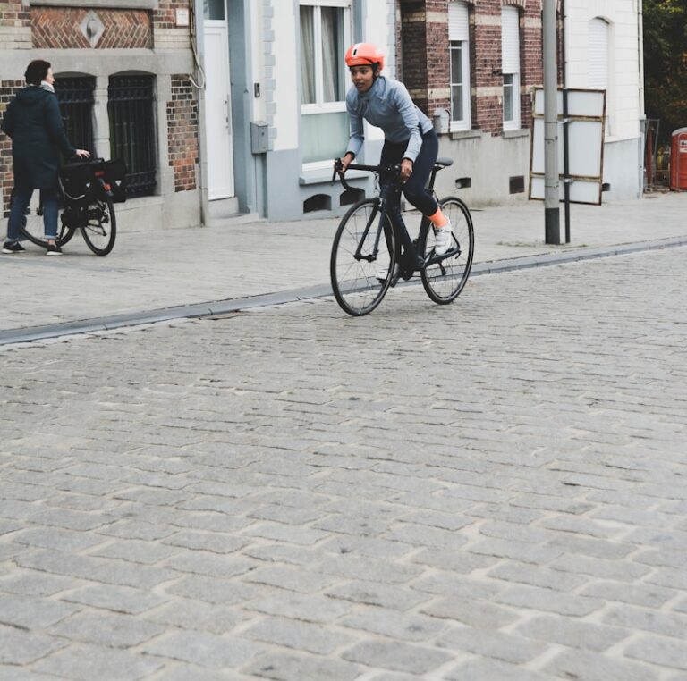 woman riding on bicycle near buldling