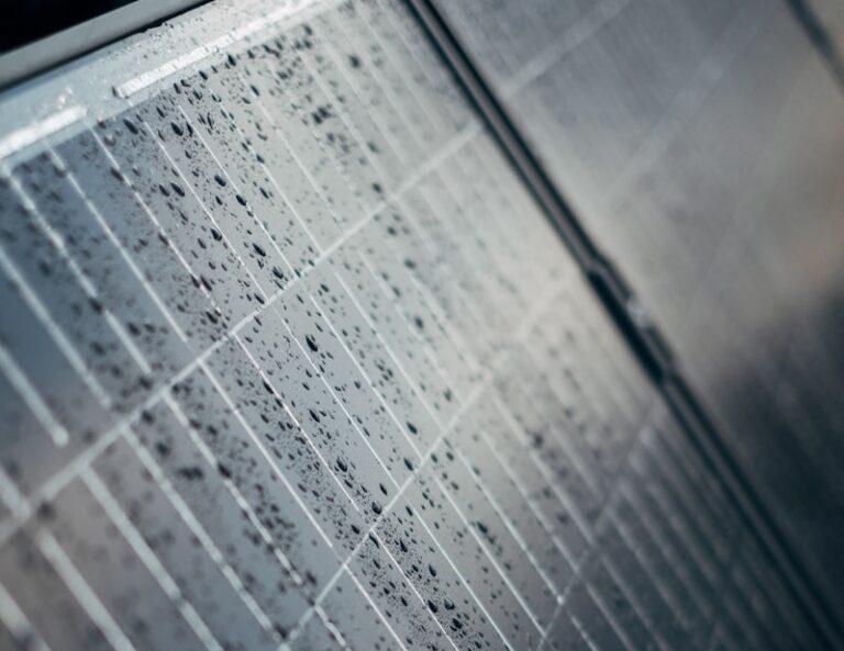 A close up of a tiled wall with water droplets