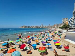 a crowded beach with umbrellas
