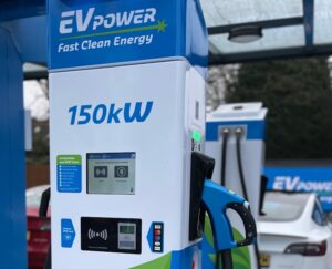 a blue and white gas pump sitting next to a white car