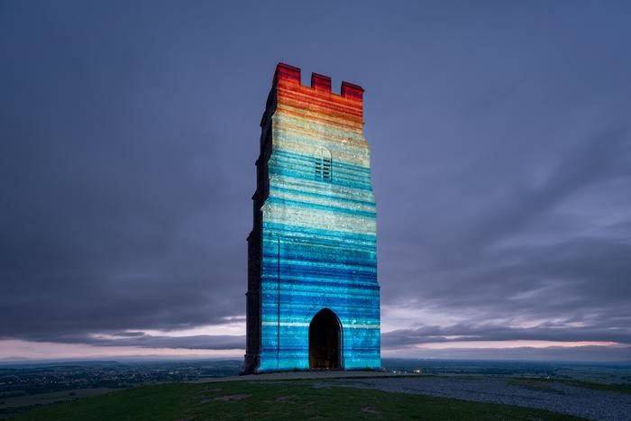 Climate stripes shine over Glastonbury Tor
