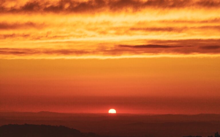 a sunset over a mountain range